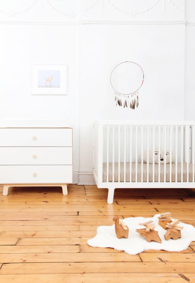 modern white crib and kid's dresser.