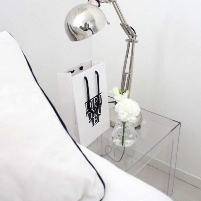 modern clear nightstand with bedroom table lamp.
